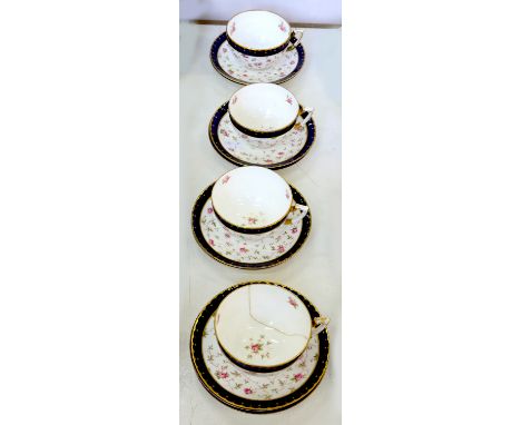 A SET OF FOUR COALPORT BREAKFAST CUPS AND NINE SAUCERS, DECORATED WITH SCATTERED ROSES, PRINTED MARK AND THAT OF THE RETAILER