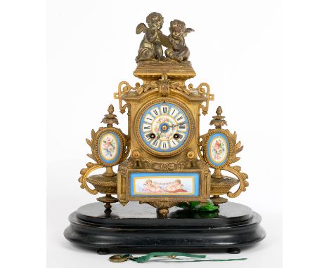 A FRENCH PORCELAIN INSET GILTMETAL MANTEL CLOCK IN LOUIS XV STYLE, THE DIAL AND PANELS PAINTED WITH FLOWERS OR PUTTI, 33CM H 