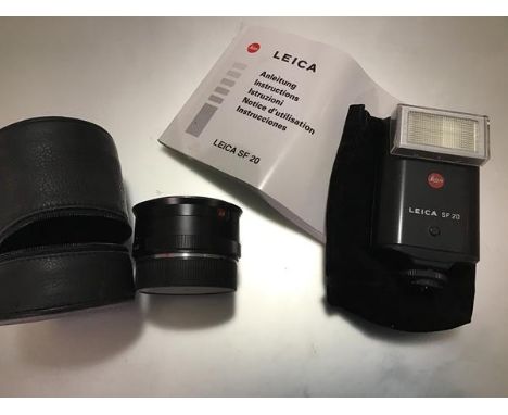 A Leica SF20 Flash (for R&amp;M mount), with instruction booklet; together with a lens adapter marked Leitz Wetzlar Germany, 