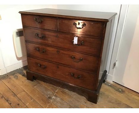 A George III mahogany chest of drawers, the rectangular top with moulded edge above two short and three long graduated drawer