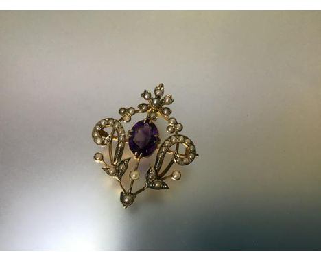 A 9ct gold brooch pendant, set with an amethyst and seed pearls, the oval-cut stone claw-set in a floral-scroll frame set wit