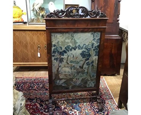 A large 19th century walnut framed needlework firescreen, the 17th/18th century style verdure panel worked with goats in a wo
