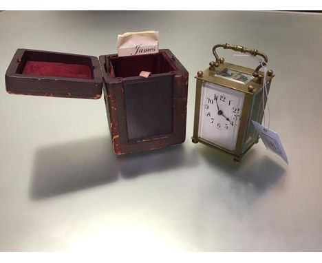 A French brass carriage clock, c. 1900, the white enamel dial with Roman numerals within a plain case with bevelled plates an