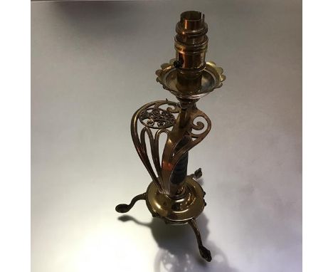 A brass table lamp formed from a Victorian swept sword hilt, with crowned cypher and sharkskin grip, raised on an a circular 