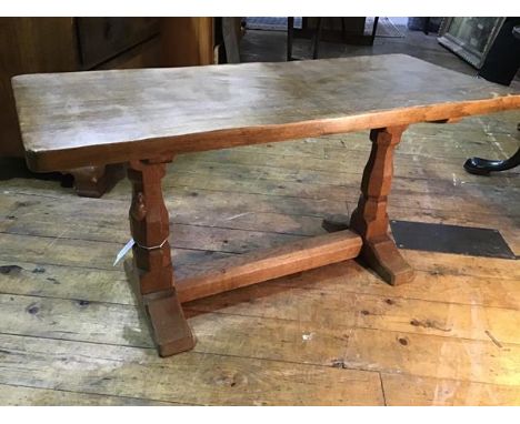 A Robert Thompson of Kilburn "Mouseman" 3' oak coffee table, c. 1990, the rectangular adzed top raised on faceted baluster tr