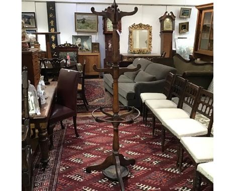 A late 19th century oak coat, hat and stick stand, the central baluster-turned standard issuing six scroll-carved hooks above