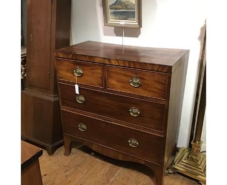 A small George III ebonised string inlaid mahogany chest of drawers, the rectangular crossbanded top over two short and two l