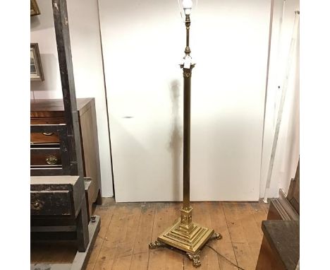 A brass Corinthian columnar standard lamp, the fluted column on a stepped square base supported on paw feet. Height inc. fitt