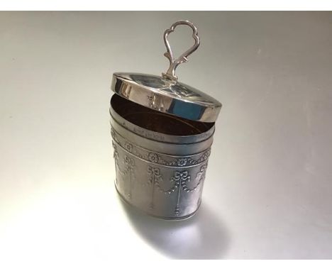 An Edwardian Adam Revival silver tea caddy, William Harrison Walter, Birmingham 1906, oval, with hinged shaped knop to the pu