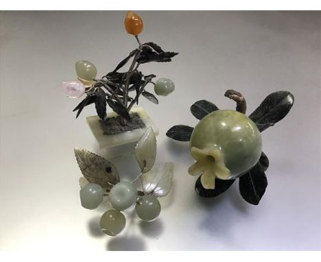 A group of Chinese jade and hardstone carvings comprising: a pomegranate  with spinach jade leaves; a bunch of grapes; and a 