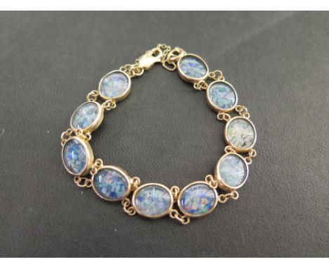 An imitation opal panel bracelet - Stamped 375 - Length 18cms - Weight approx 11.0gms
Condition Report: Good - With light sur