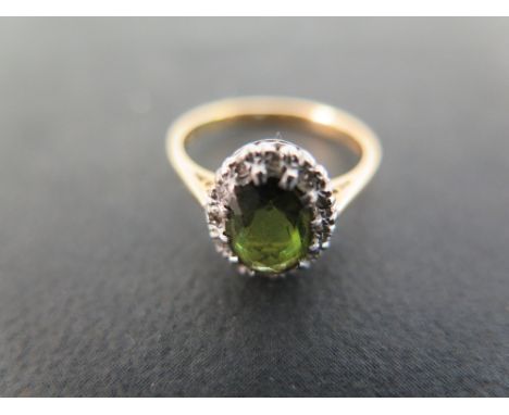 A tourmaline and diamond cluster ring - Stamped 18ct - Ring size K - Weight approx 2.8gms
Condition Report: Good - With light