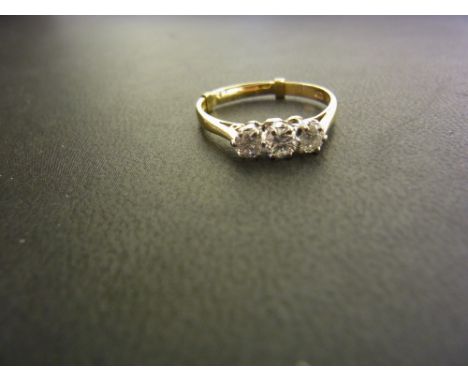 An 18ct gold graduated diamond three-stone ring - Estimated total diamond weight 0.50ct - Hallmarked London - Ring size R 1/2