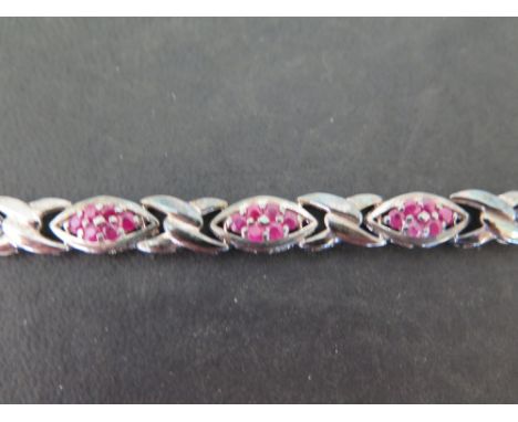 A ruby panel bracelet - Stamped 925 - Length 18cms - Weight approx 15.0gms.
Condition Report: Good to fair - With some surfac