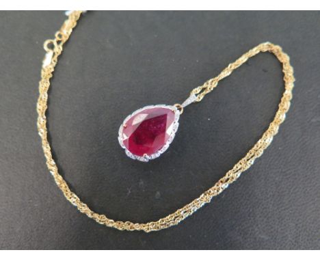A 9ct gold glass filled ruby and diamond pendant - Suspended from a fancy-link chain - Hallmarked Birmingham - Length of pend