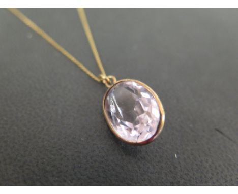 An amethyst pendant - Suspended from a fancy-link chain - Chain stamped 750 - Length of pendant 2cms - Length of chain 64cms 
