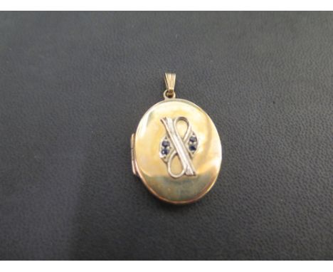 A 9ct gold oval photo locket with sapphire detail - Hallmarked Birmingham - Length 4cms - Weight approx 9.1gms
Condition Repo