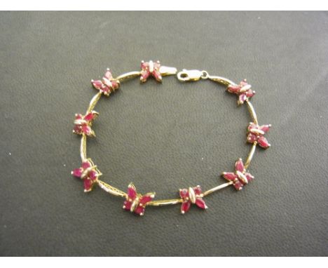 A 9ct gold ruby butterfly bracelet - Hallmarked Birmingham - Length 17.5cms - Weight approx 6.8gms
Condition Report: Good