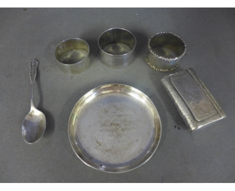 Three silver napkin rings, a silver spoon, a small silver dish and a snuff box which tests as silver - Total approx. weight 7