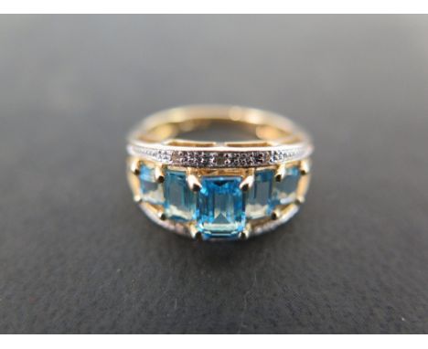 A topaz and diamond dress ring - To the openwork shoulders and plain half-band - Stamped 14Kt - Ring size K 1/2 - Weight appr