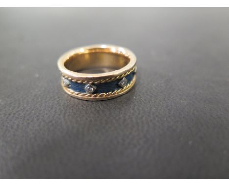 An 18ct gold diamond and enamel full-circle band ring - Hallmarked London - Ring size M 1/2 - Weight approx 8.2gms
Condition 