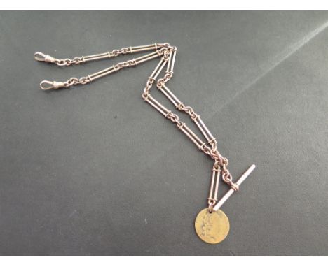 An early to mid 20th century 9ct gold fetter and three double Albert chain - Suspending two toggles, a T-bar and a yellow met
