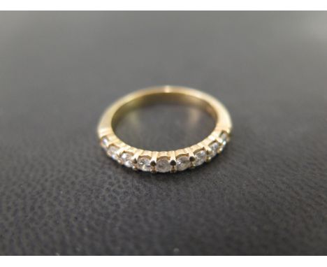 A brilliant-cut diamond nine-stone ring - Diamond weight 0.55ct, stamped to band - Tests as gold - Ring size M 1/2 - Weight a