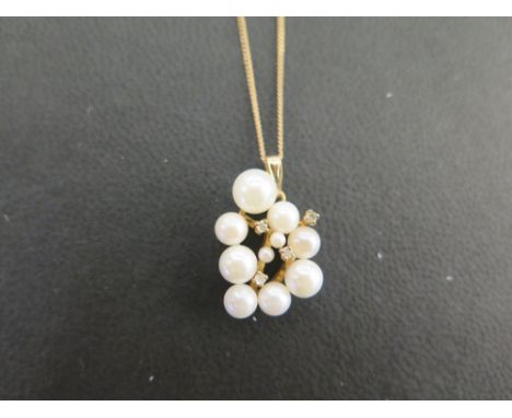 A 9ct gold cultured pearl and diamond cluster pendant - Suspended from a fine curb-link chain - Hallmarked Birmingham - Lengt