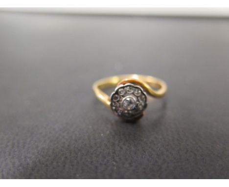 A diamond crossover style cluster ring - Stamped 18ct - Ring size N 1/2 - Weight approx 3.1gms
Condition Report: Good to fair