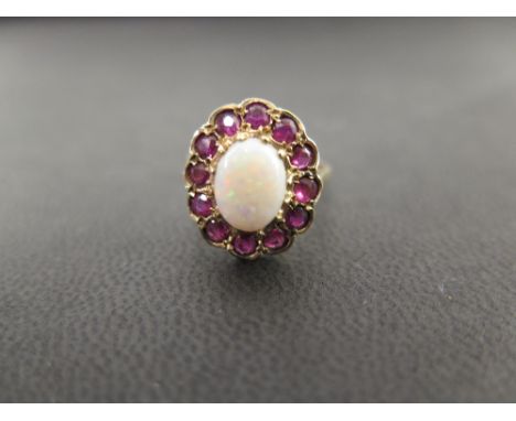 A 9ct gold opal and ruby cabochon ring - Hallmarked London - Ring size K - Weight approx 3.6gms
Condition Report: Good