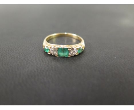 An emerald and diamond dress ring - The alternating old-cut diamonds and square-shape emeralds to the carved gallery and plai