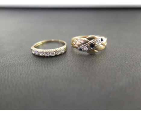 A 9ct gold sapphire and white-gem ring  - Together with a 9ct gold cubic zirconia seven-stone ring - Both ring size K - Hallm