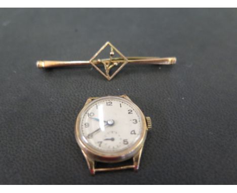 A bar brooch and a wristwatch head - Brooch stamped 9ct - Length 5.2cms - Total weight approx 9.8
Condition Report: Good to f