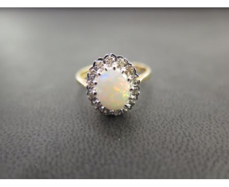 An 18ct gold opal and diamond cluster ring - Hallmarked London - Ring size P 1/2 - Weight approx 4.7gms
Condition Report: Goo