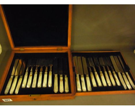 A boxed set of twelve mother of pearl handled knives and forks
