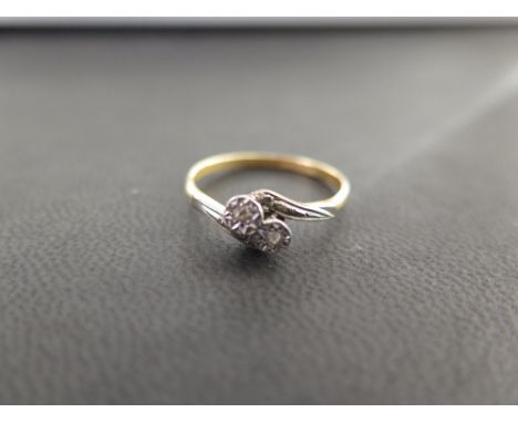 A two-stone diamond crossover ring - Stamped 18ct and Plat - Ring size R - Weight approx 2.3gms
Condition Report: Good - With