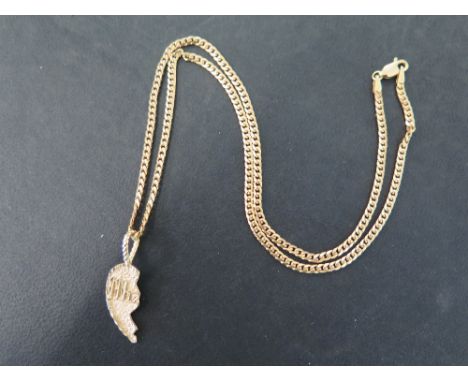 A curb-link chain - Stamped 375 - Length 45cms - Suspending a half heart pendant - Length 3cms - Total weight approx 9.4gms.
