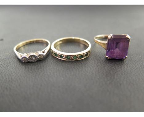 Three rings - To include an amethyst single-stone - A diamond three-stone - Together with an emerald seven-stone band ring - 