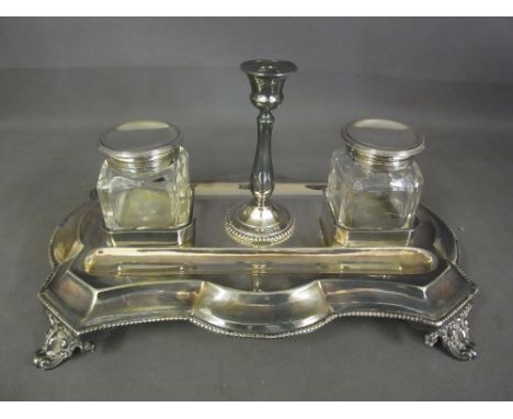 A silver twin bottle desk stand of shaped form with central taper stick - London 1864/65 - maker R H - rubbed to bottles - We