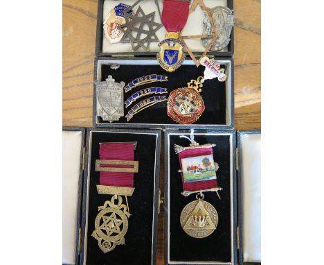 Two silver gilt Masonic jewel medals one with enamel band and ten other badges and medals