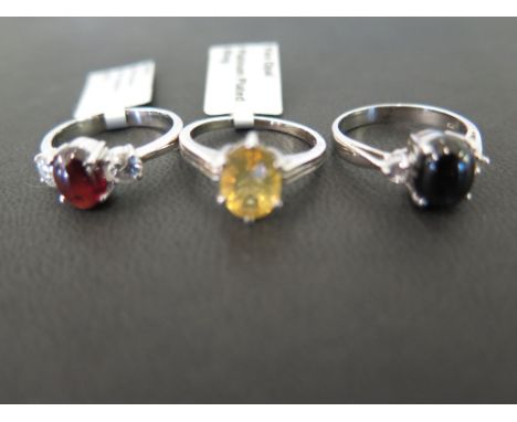 Three gem-set rings - to include fire opal, star diopside and garnet - Stamped 925 - Ring size N and N 1/2 - Weight approx 8.