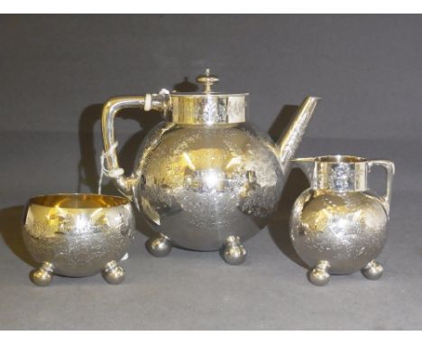 A Victorian silver three piece Bachelors tea service of globular form with chased and engraved foliage decoration the teapot 