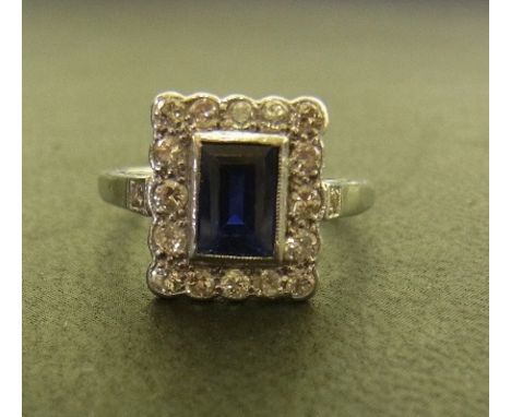 A sapphire and diamond cluster ring - The rectangular sapphire within a brilliant-cut diamond surround - Stamped plat - Ring 