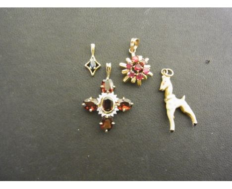 A group of four pendants - To include a ruby cluster, Stamped 18K, Weight approx 1.9gms - A sapphire pendant Stamped 375 - An