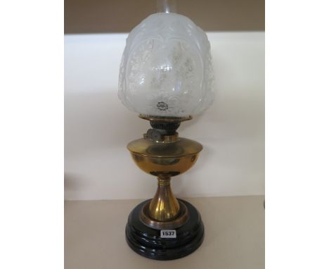 An Edwardian brass oil lamp with an opaque molded and etched Art Nouveau shade