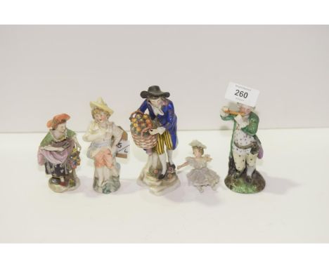 A collection of various early ceramic figures Including flute player, fruit seller, etc. (6) 