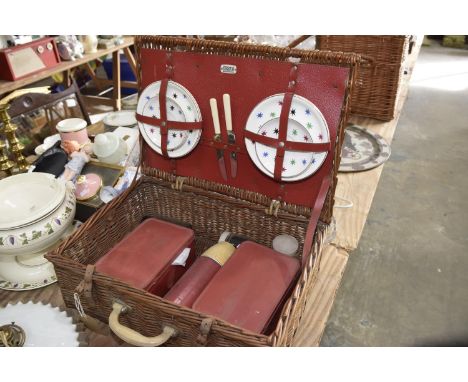 A vintage wicker Sirram picnic basketThe wicker basket contains four plates, three saucers - both Victoria & Trentham Potteri