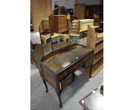 A Mid 20th Century walnut Queen Anne style dressing table with triple mirror. 