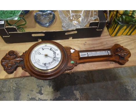 A wooden cased barometer With white dial. 