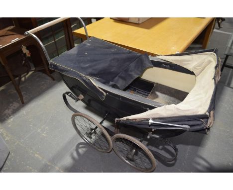 A Vintage Dunkley pram on a sprung chassis with rubber wheels. 